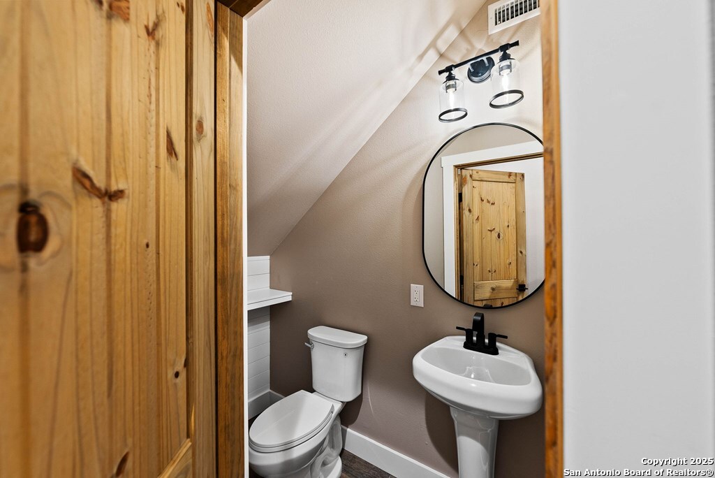 502 Sumack Kerrville, TX 78028 - Photo 34 of 58 a bathroom with a toilet sink and mirror