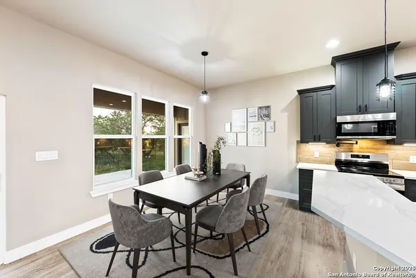 a kitchen with kitchen island a sink a counter top stainless steel appliances and cabinets