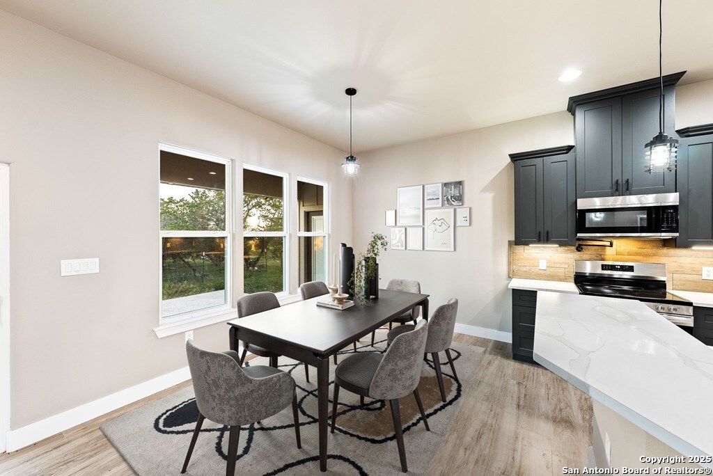 502 Sumack Kerrville, TX 78028 - Photo 8 of 58 a view of a dining room with furniture window and wooden floor