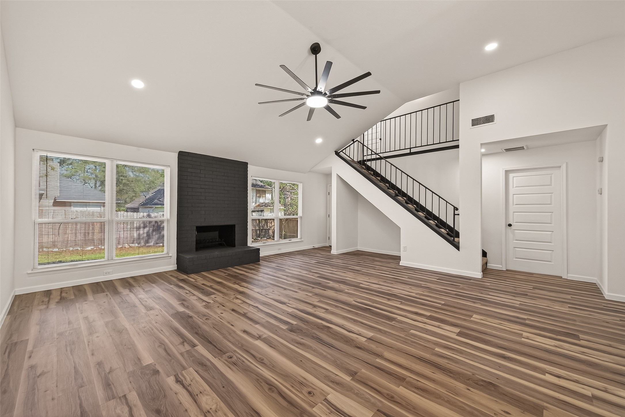 2915 Whispering Springs Drive Spring, TX 77373 - Photo 5 of 36 Cozy living space featuring a modern painted brick fireplace and large windows overlooking the backyard.