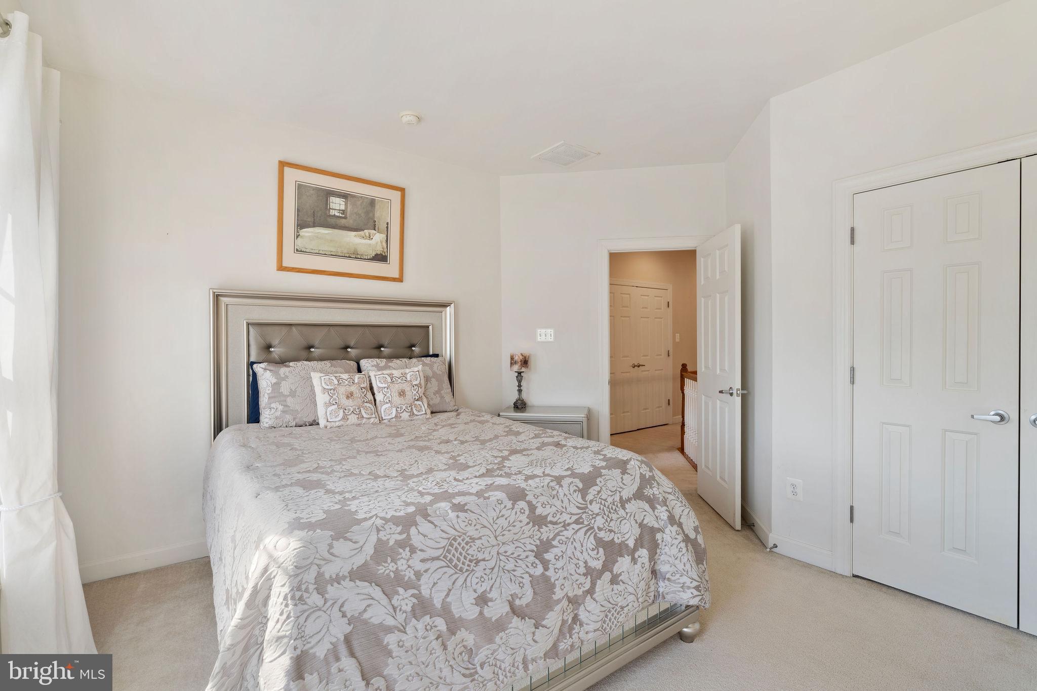 5102 Hugunin Way Perry Hall, MD 21128 - Photo 27 of 45 a bedroom with a bed and a painting on the wall