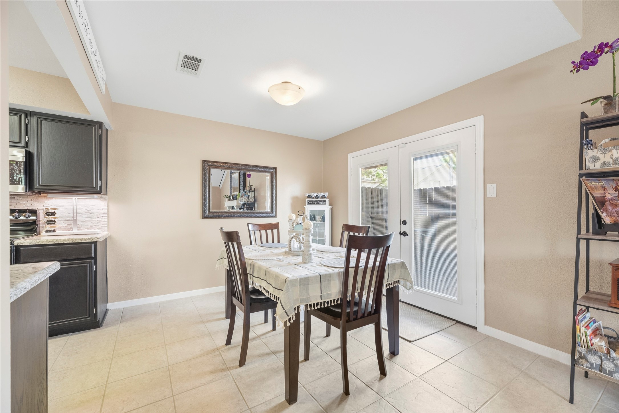 16913 Chapel Pines Drive, Unit 126 Spring, TX 77379 - Photo 8 of 27 Bright breakfast area with tile flooring and French doors opening to the outside, covered patio.