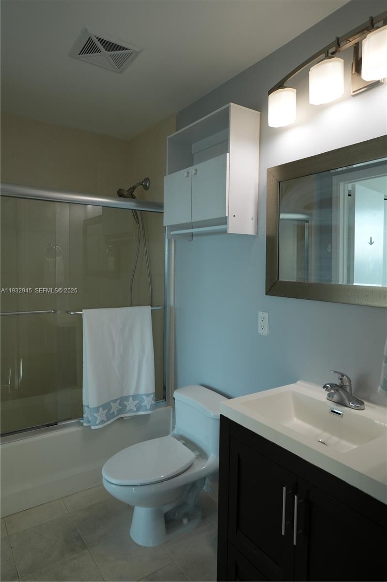 60 Southwest 13th Street, Unit 1901 Miami, FL 33130 - Photo 12 of 17 a bathroom with a sink a toilet and shower
