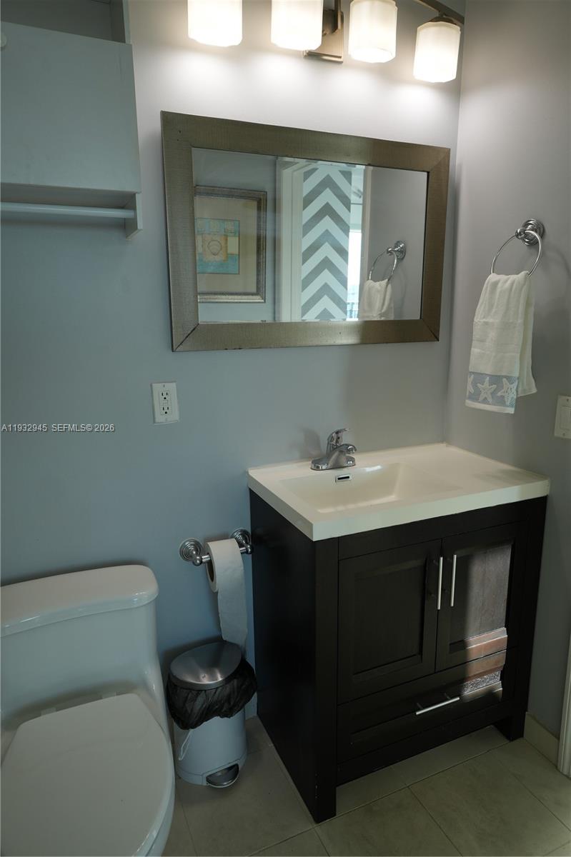 60 Southwest 13th Street, Unit 1901 Miami, FL 33130 - Photo 13 of 17 a bathroom with a sink toilet and mirror