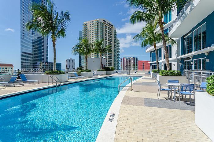 60 Southwest 13th Street, Unit 1901 Miami, FL 33130 - Photo 2 of 17 a swimming pool with outdoor seating and yard