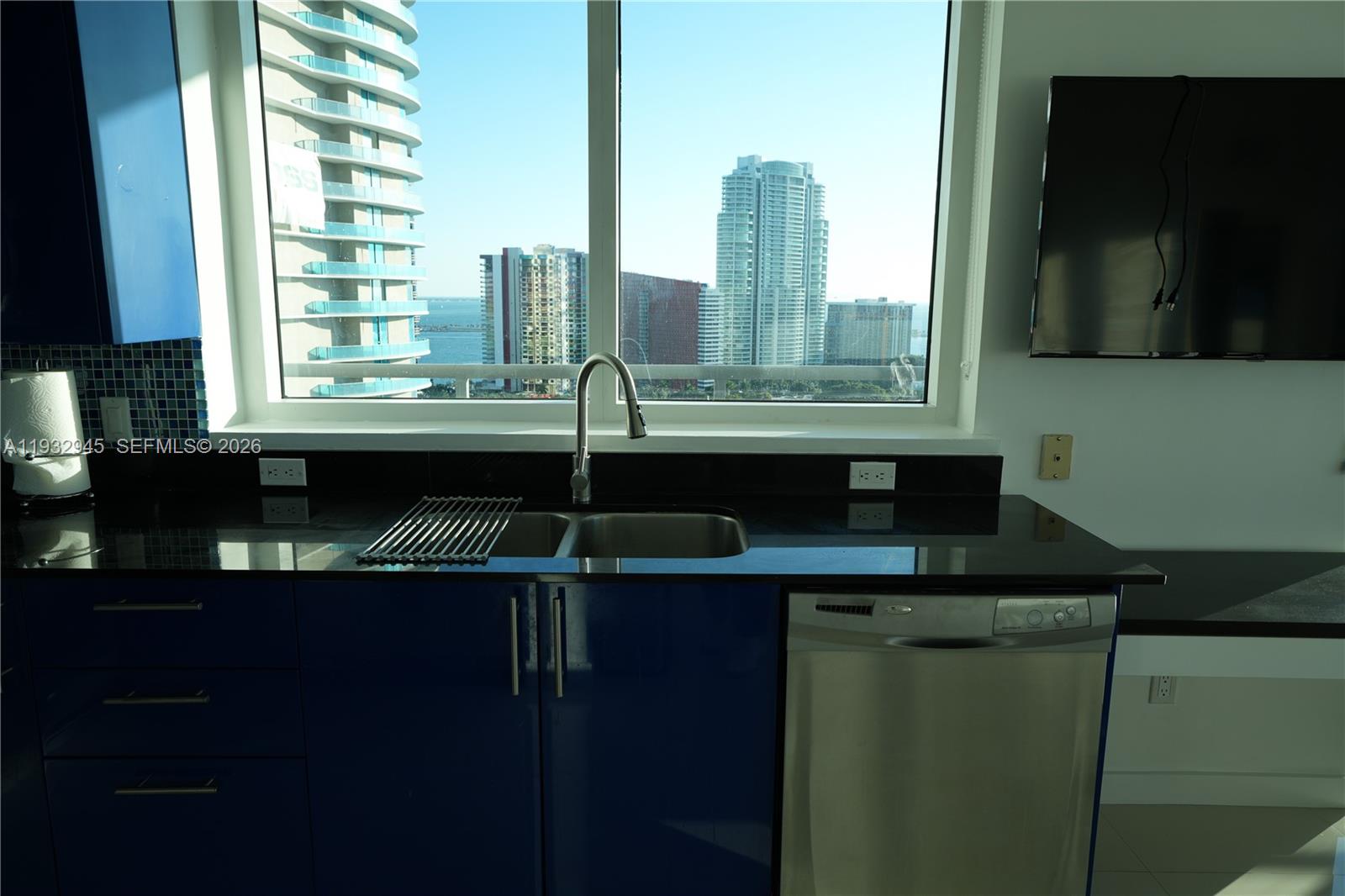 60 Southwest 13th Street, Unit 1901 Miami, FL 33130 - Photo 7 of 17 a kitchen with a sink and a microwave