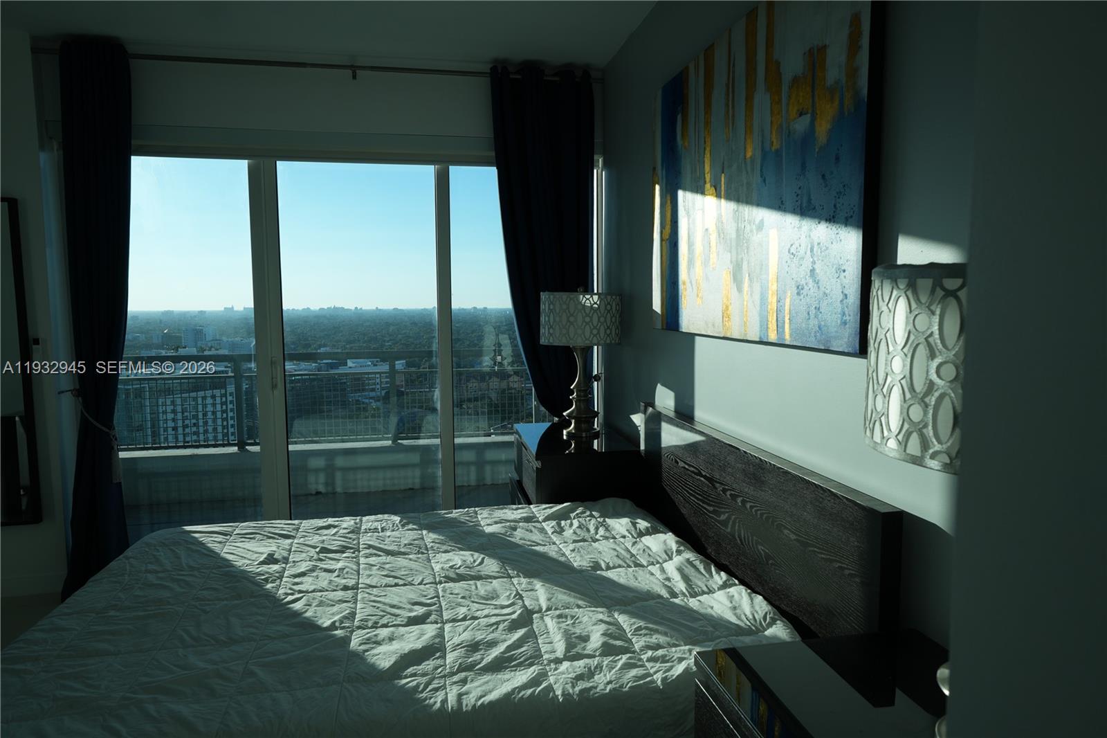 60 Southwest 13th Street, Unit 1901 Miami, FL 33130 - Photo 10 of 17 a bedroom with a bed and a window