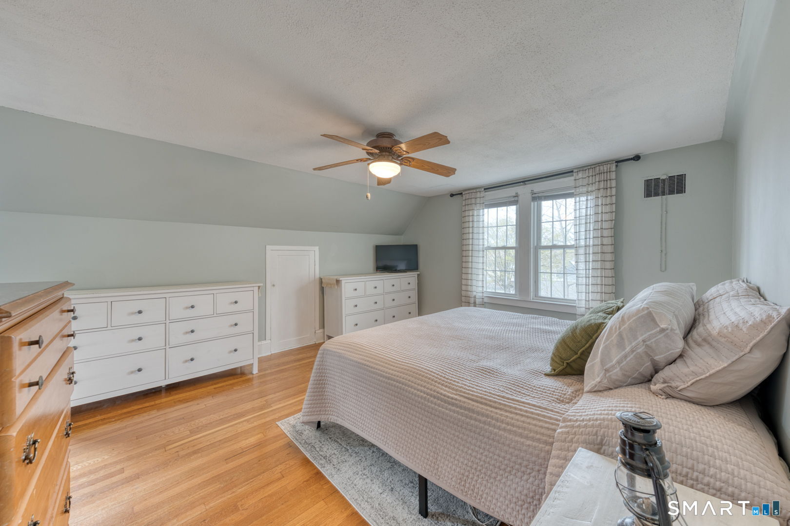 112 Fitzgerald Boulevard Coventry, CT 06238 - Photo 16 of 25 a bedroom with a bed a window dresser and a fireplace