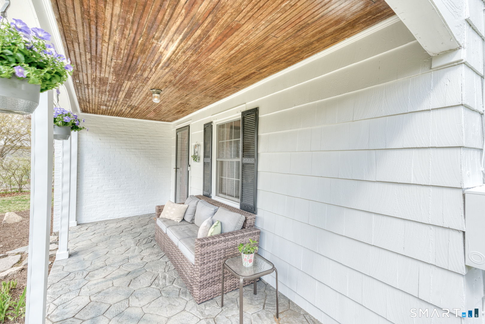 112 Fitzgerald Boulevard Coventry, CT 06238 - Photo 5 of 25 a porch with a bench and a chair