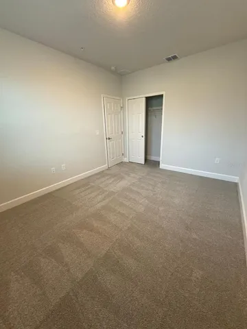 a view of an empty room and closet area