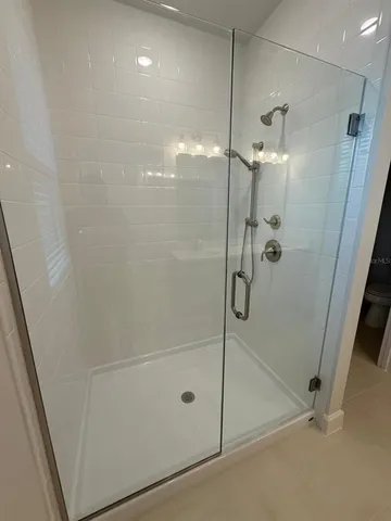 a bathroom with a glass shower door