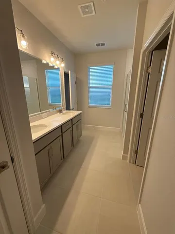 a bathroom with a tub sink and mirror
