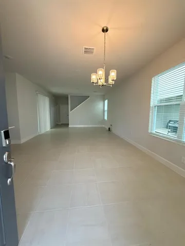 a view of an empty room with a chandelier