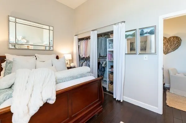 a bedroom with a bed and a mirror