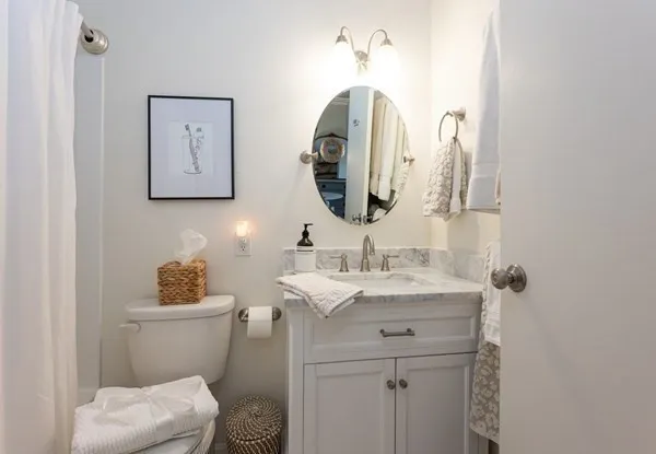 a bathroom with a toilet sink and mirror