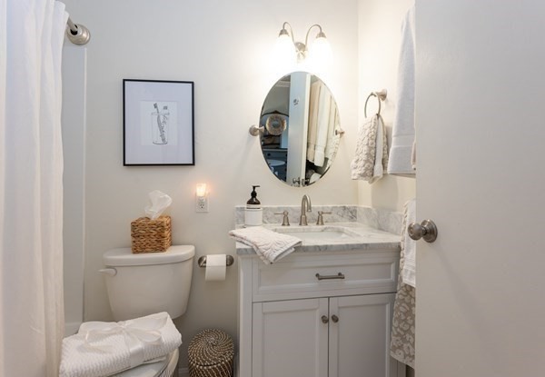 16 Balmoral Street, Unit 410 Andover, MA 01810 - Photo 21 of 34 a bathroom with a toilet sink and mirror
