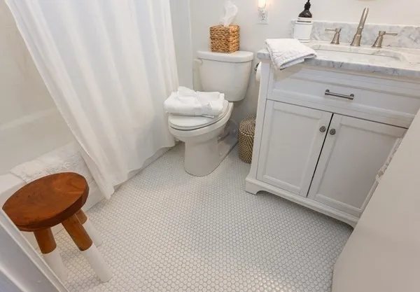 a bathroom with a toilet a sink and a mirror