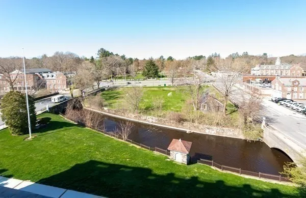 an aerial view of residential houses with outdoor space and trees
