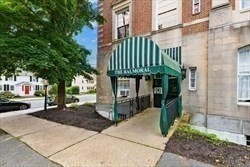 16 Balmoral Street, Unit 410 Andover, MA 01810 - Photo 32 of 34 a front view of a building with a garden
