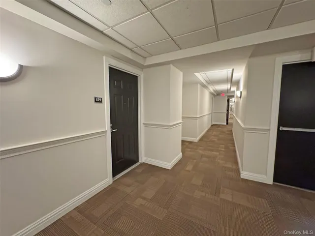a view of empty room with wooden floor and fireplace