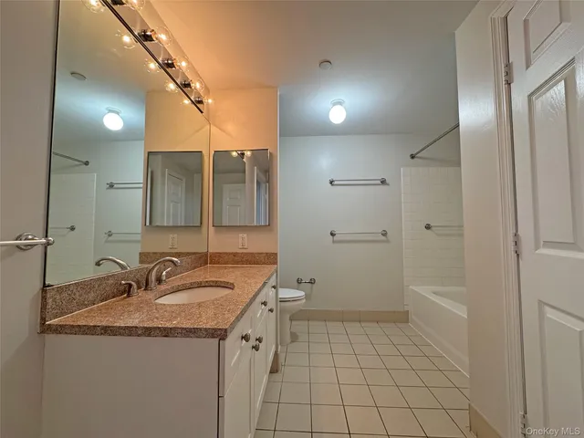 a bathroom with a sink a toilet and mirror