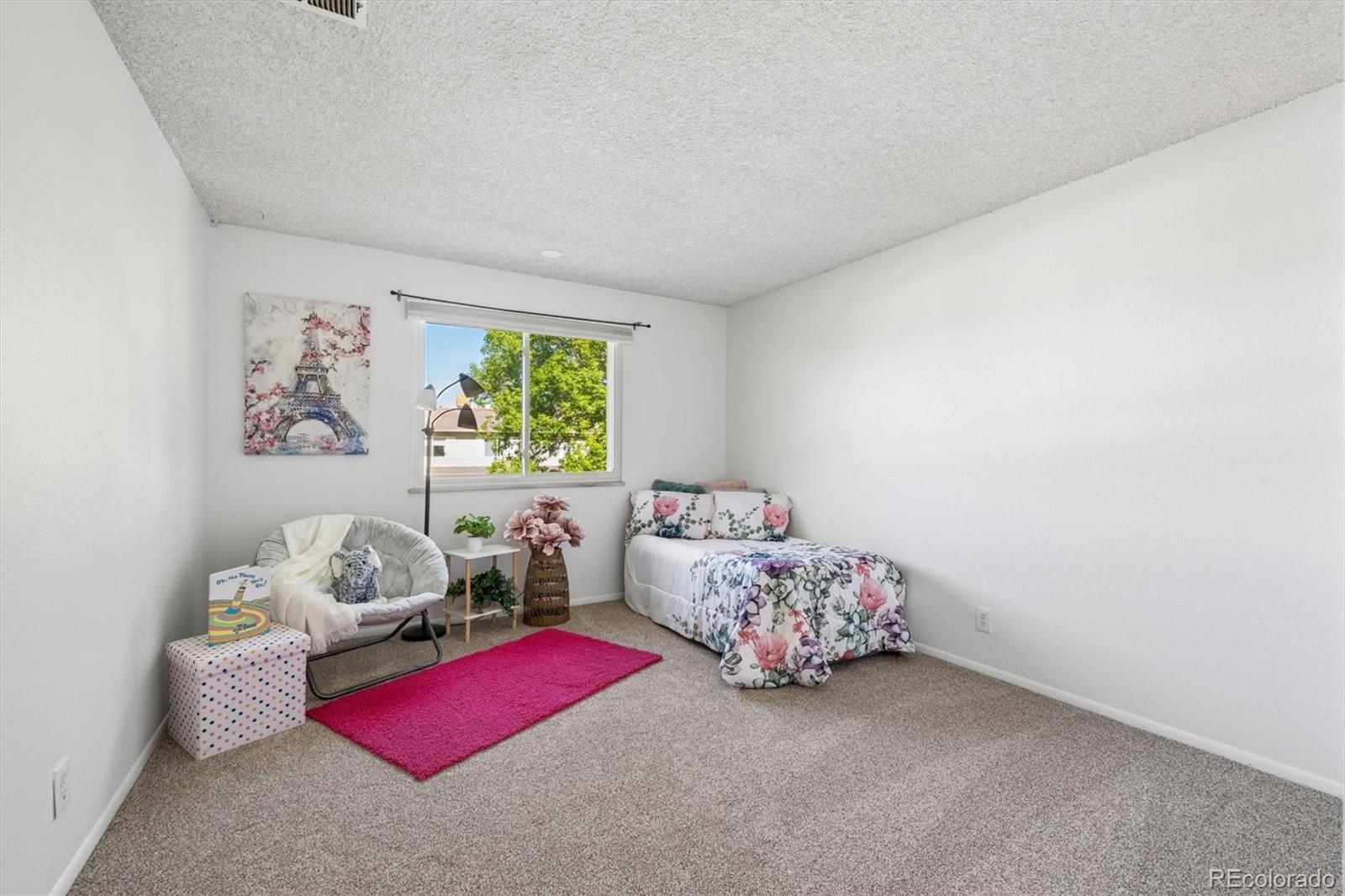 9768 Lane Street Thornton, CO 80260 - Photo 11 of 18 a bedroom with furniture and a window