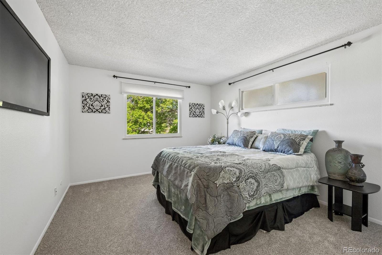 9768 Lane Street Thornton, CO 80260 - Photo 13 of 18 a bedroom with a bed and a window