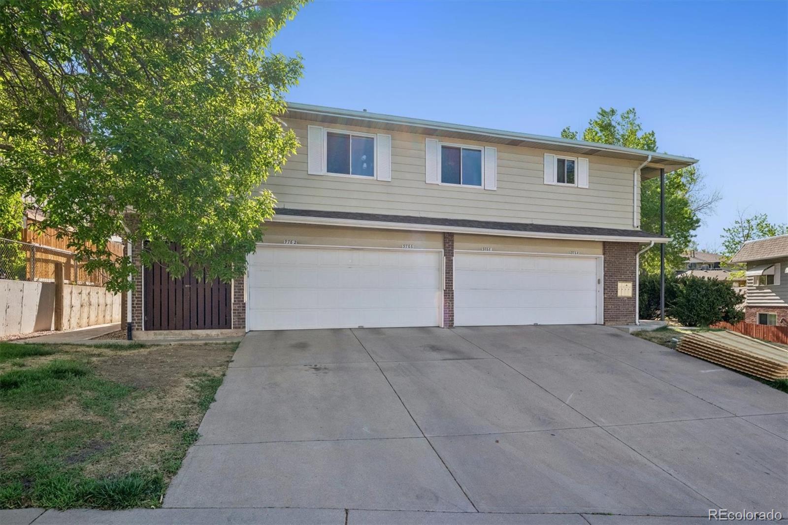 9768 Lane Street Thornton, CO 80260 - Photo 15 of 18 front view of a house with a street