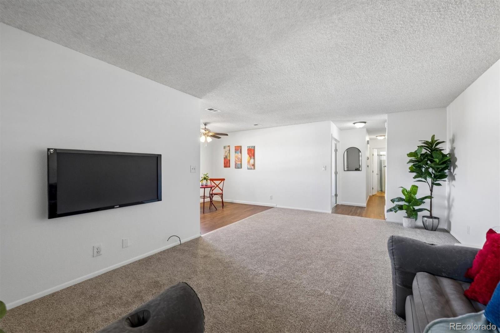 9768 Lane Street Thornton, CO 80260 - Photo 5 of 18 a living room with furniture and a flat screen tv