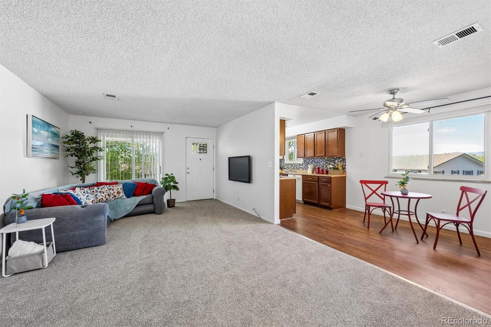 9768 Lane Street Thornton, CO 80260 - Photo 6 of 18 a living room with furniture and kitchen view