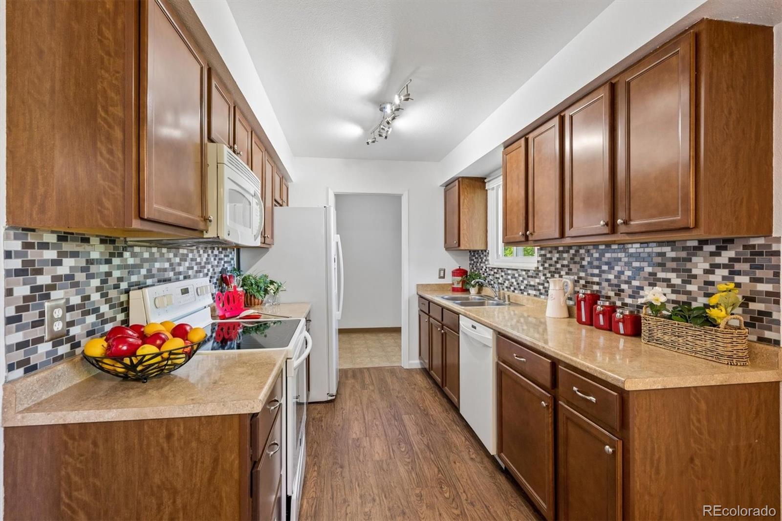 9768 Lane Street Thornton, CO 80260 - Photo 8 of 18 a kitchen with sink cabinets and appliances