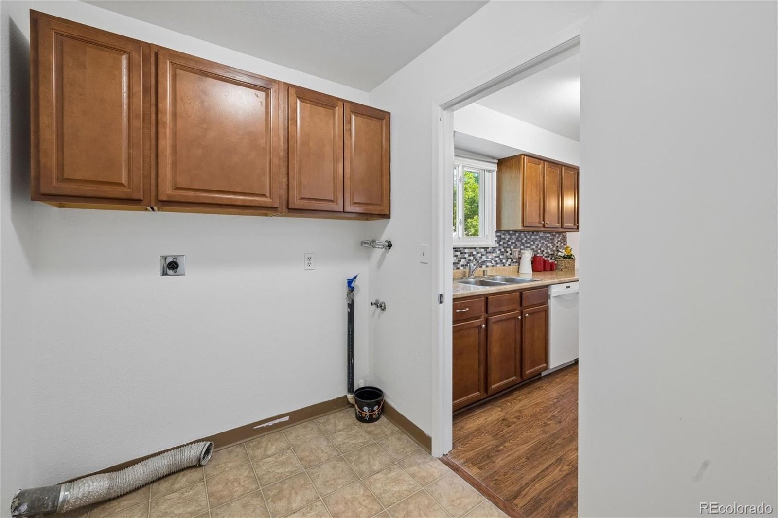 9768 Lane Street Thornton, CO 80260 - Photo 10 of 18 a kitchen with stainless steel appliances a refrigerator and cabinets