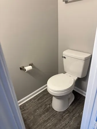 a white toilet sitting in a bathroom