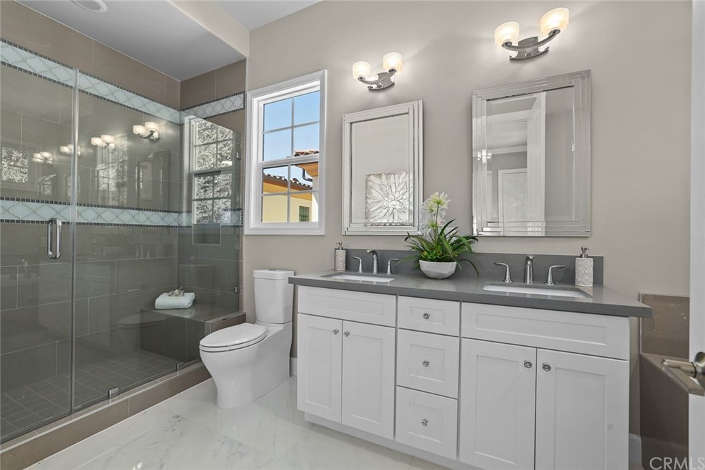 1015 Holly Avenue, Unit B Arcadia, CA 91007 - Photo 32 of 39 a bathroom with a granite countertop sink a toilet and a mirror