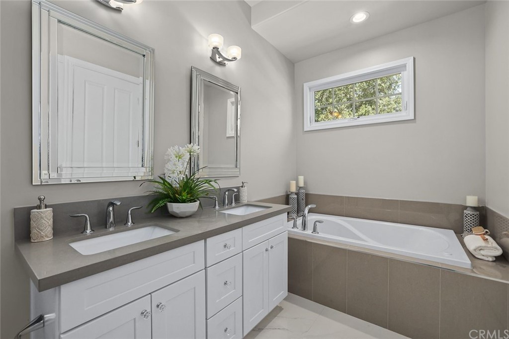 1015 Holly Avenue, Unit B Arcadia, CA 91007 - Photo 33 of 39 a bathroom with a granite countertop tub sink and mirror