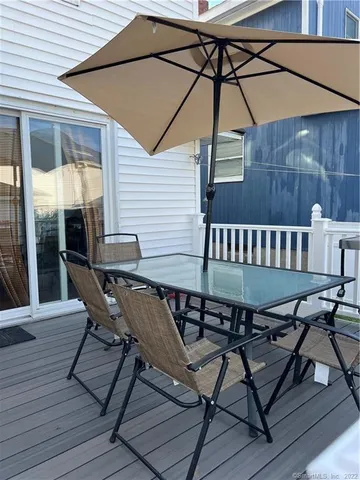 a view of a roof deck with chair and wooden floor