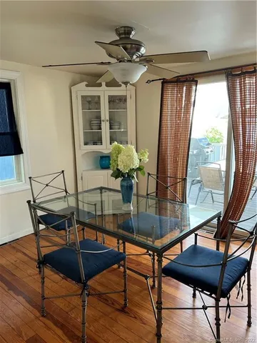 a room with table chairs and wooden floor