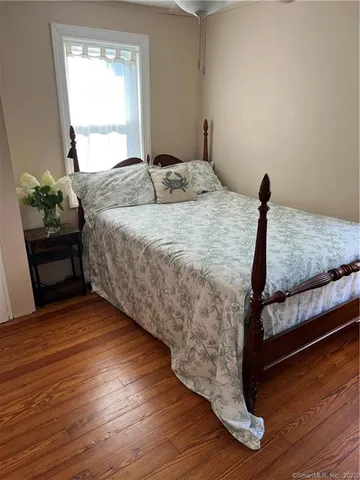 a bedroom with a bed and a potted plant