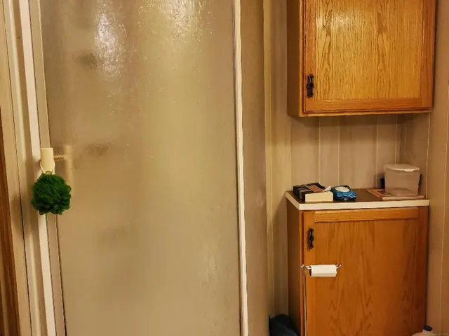 a bedroom with a bed and a mirror