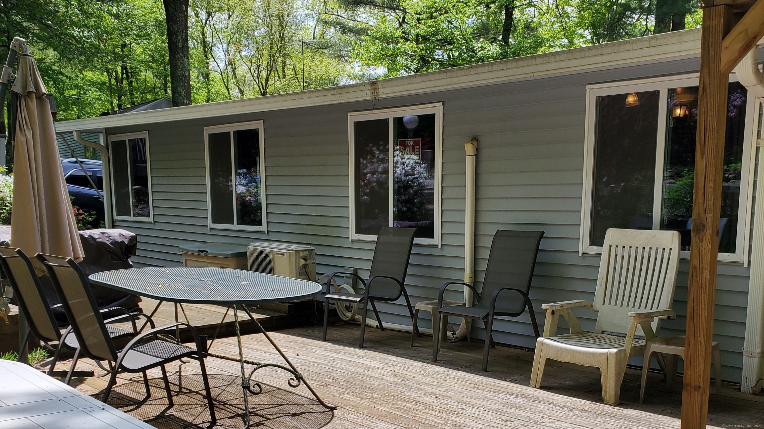 8 S Road, Unit WW4 Stafford, CT 06076 - Photo 2 of 23 a backyard of a house with table and chairs