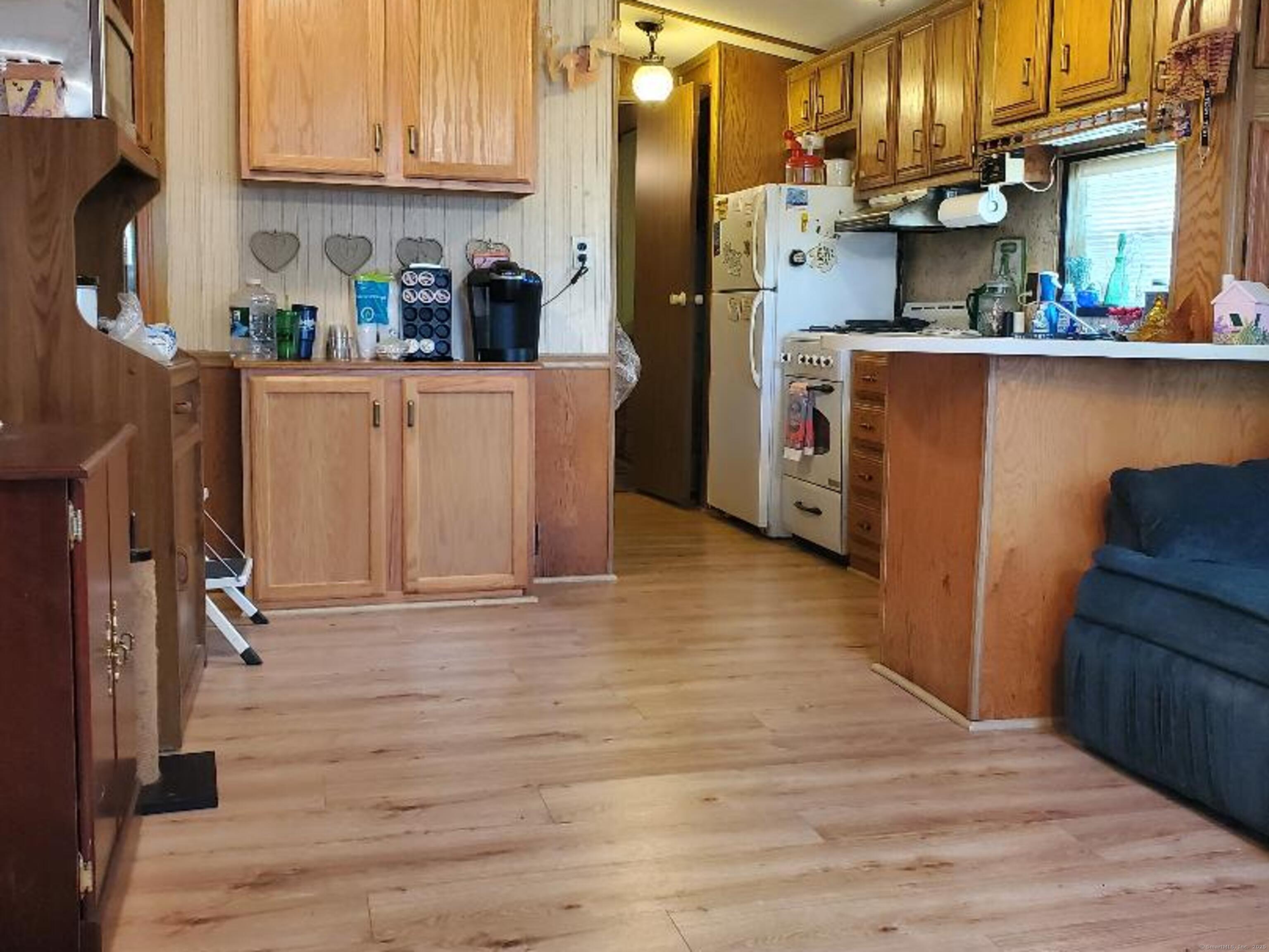 8 S Road, Unit WW4 Stafford, CT 06076 - Photo 6 of 23 a kitchen with stainless steel appliances a refrigerator and wooden floor