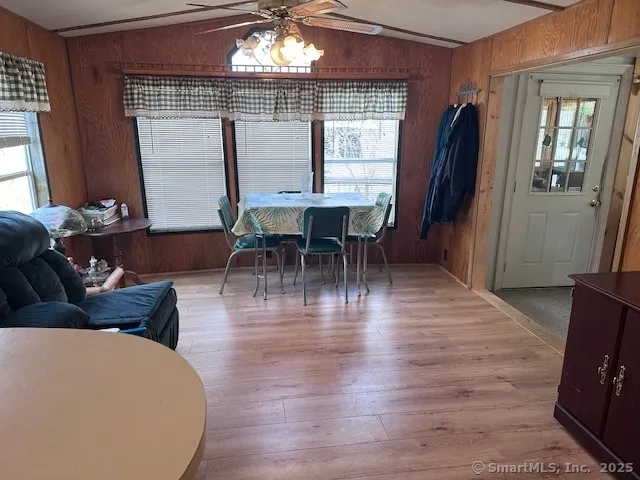 a dining room with furniture and wooden floor