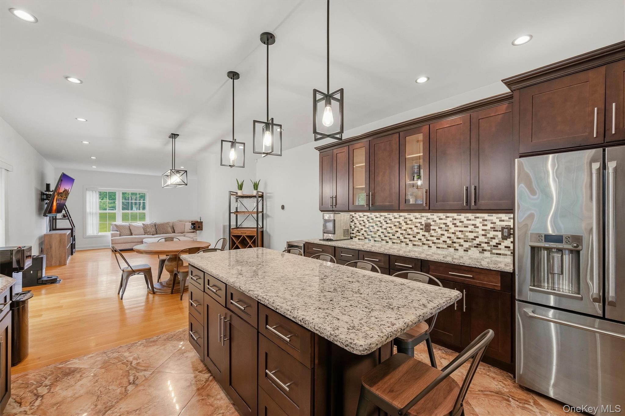 8 Darmstadter Road Bloomingburg, NY 12721 - Photo 18 of 47 Kitchen with 7 foot 7 inch center island that seats 6, Cafe appliances, granite countertops, tile backsplash, uplighting, Recessed lighting, marble tile floors and 9 foot ceilings.
