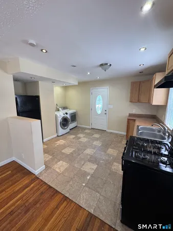 a bedroom with a bed and a view of kitchen