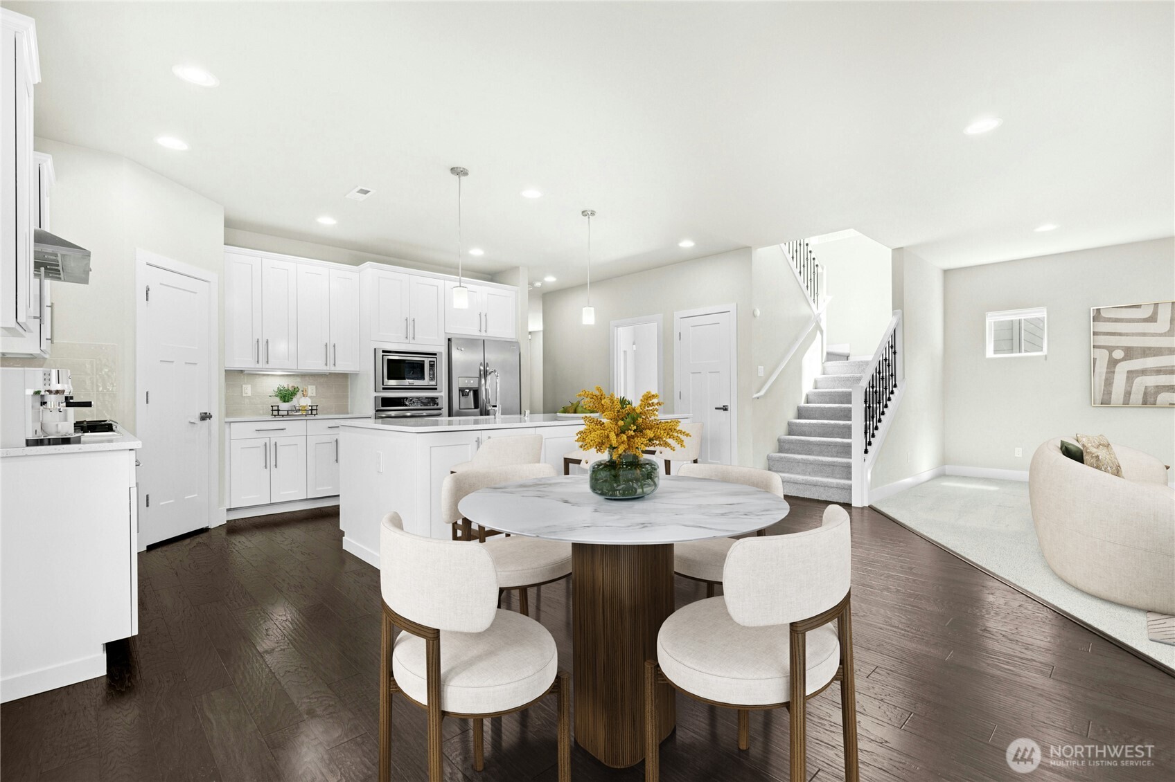 19814 11th Drive Southeast Bothell, WA 98012 - Photo 11 of 32 a kitchen with stainless steel appliances kitchen island granite countertop a dining table chairs and a refrigerator