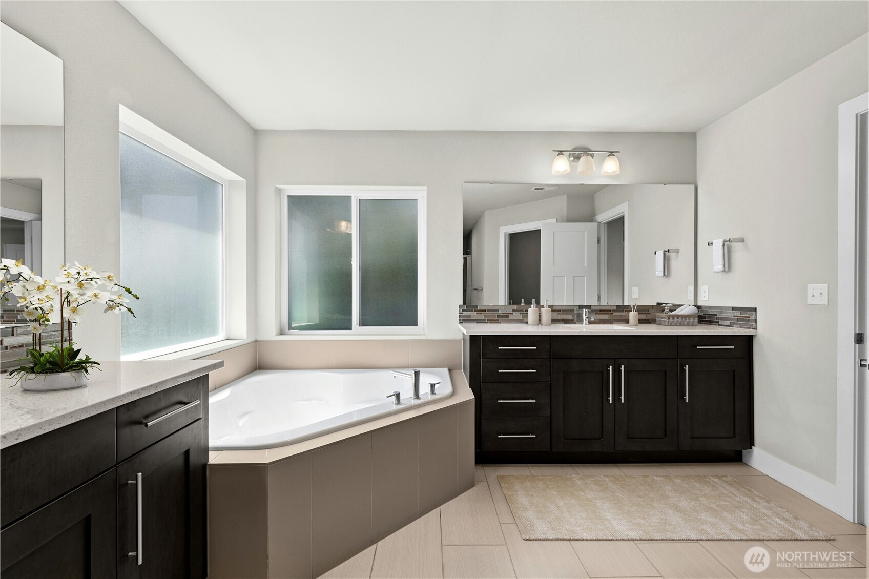 19814 11th Drive Southeast Bothell, WA 98012 - Photo 22 of 32 a bathroom with a tub sink and mirror