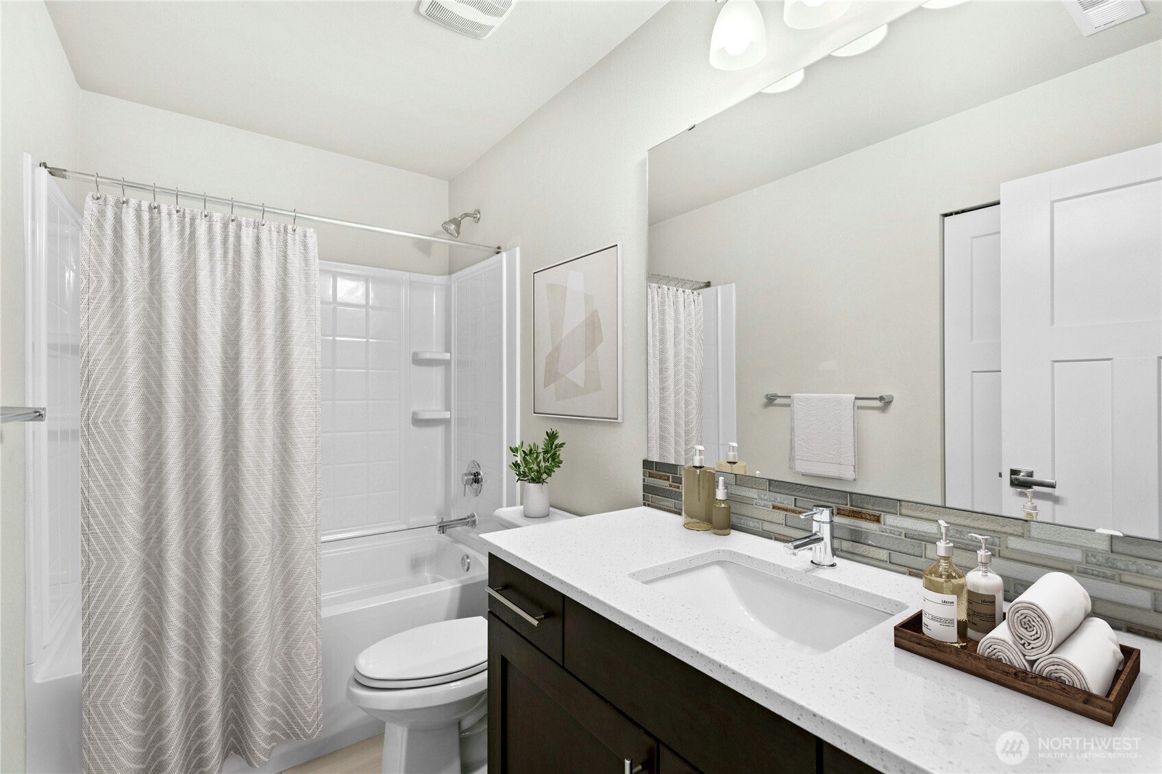 19814 11th Drive Southeast Bothell, WA 98012 - Photo 27 of 32 a bathroom with a granite countertop sink toilet and shower
