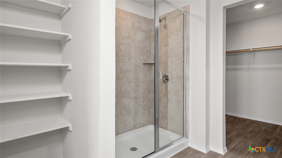2227 Turmeric Court Temple, TX 76501 - Photo 15 of 22 a bathroom with a glass shower door