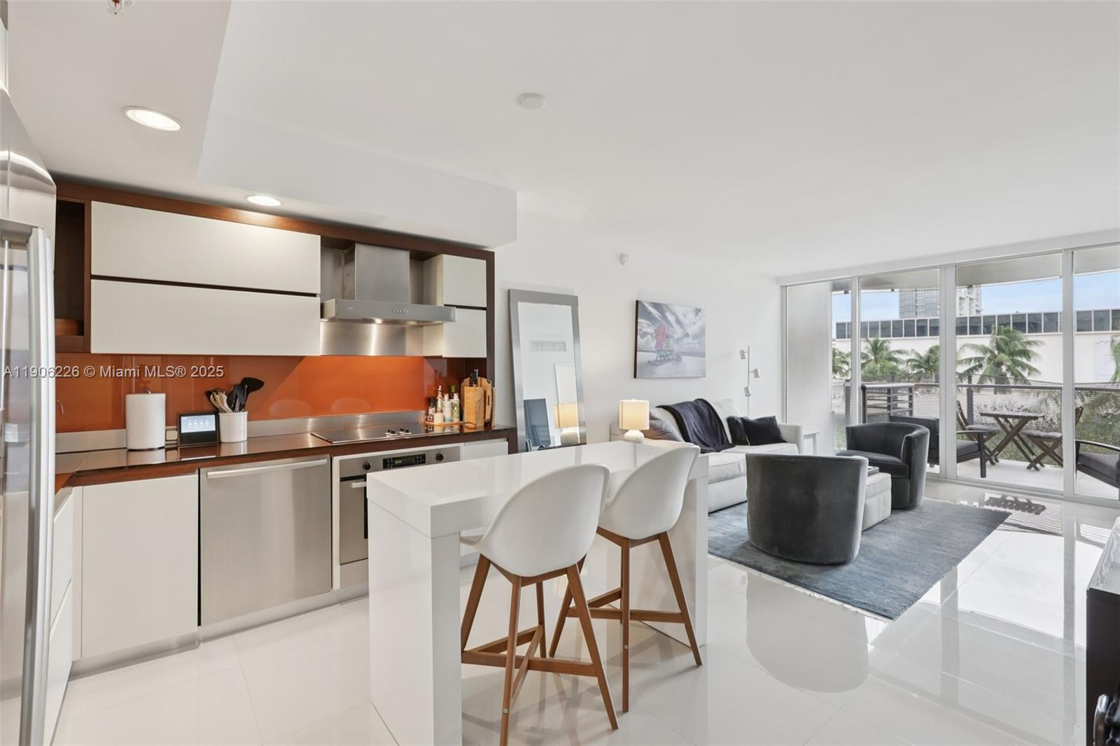 2155 Washington Court, Unit 303 Miami Beach, FL 33139 - Photo 11 of 35 a dining hall with stainless steel appliances granite countertop a stove and a refrigerator