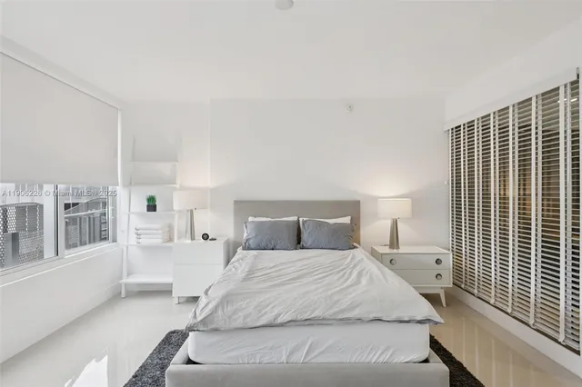 a large white bed in a white room